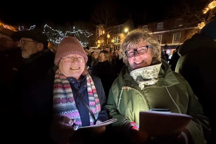 Singing along to the Christmas Carols with the music played by Crediton Town Band.  AQ 1240
