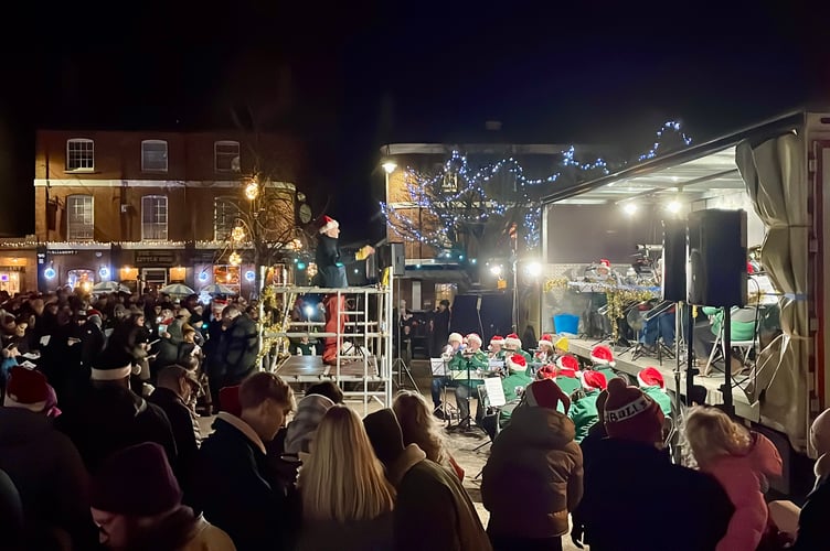 23 December 2025 Crediton Town Band Carols in the Square Crowd singing as Crediton Town Band played a carol (Will Goddard, Crediton Courier)