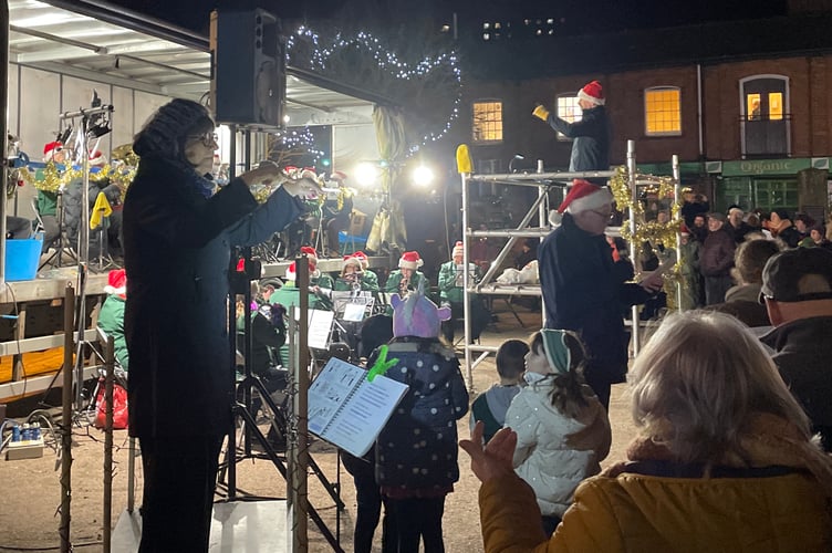 23 December 2025 Crediton Town Band Carols in the Square Lesley Rogers provided signed support for the deaf and hard-of-hearing (Will Goddard, Crediton Courier)