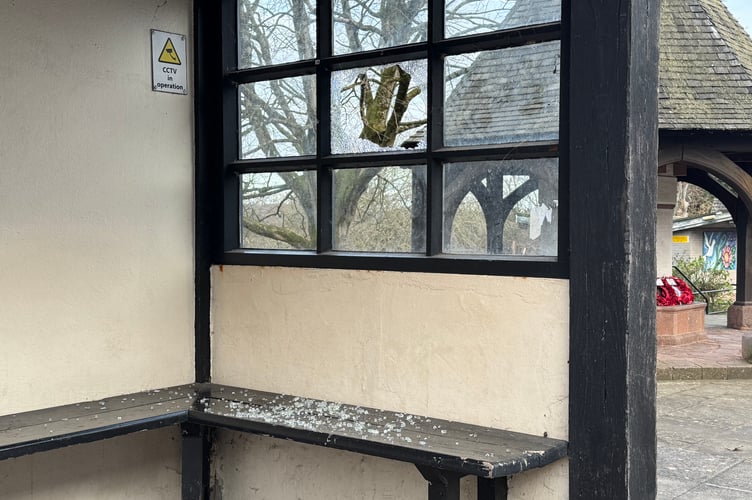 The smashed window and broken glass on seating in the Union Road bus stop.  AQ 1431
