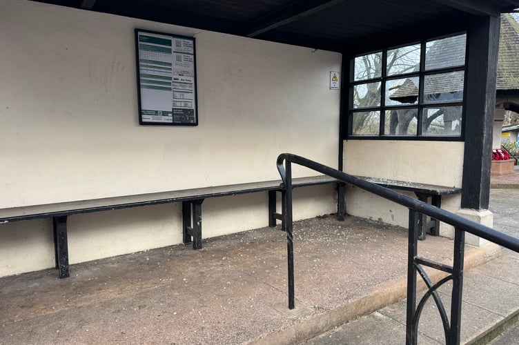 Broken glass across the floor and seating area in the Union Road bus stop.  AQ 1429
