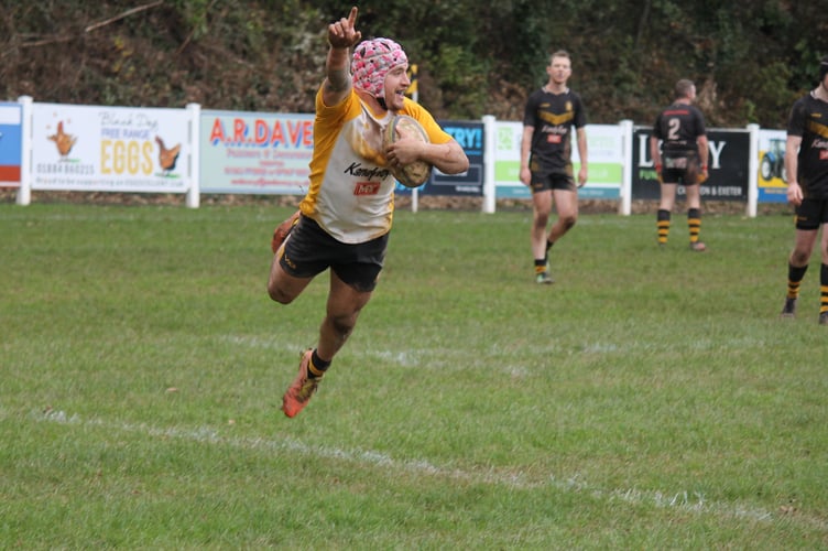 A Crediton player celebrating his try as he took a flying touchdown.  AQ 0885
