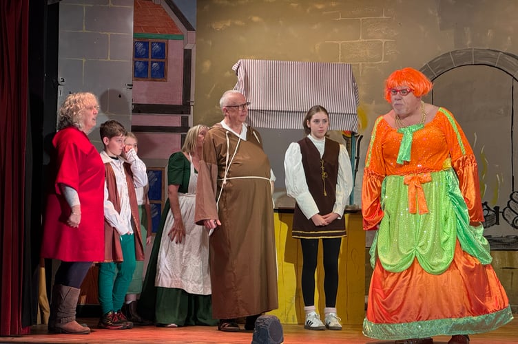 The dame, Molly Coddle, played by Mike Fox, and some of the cast on stage at Tedburn St Mary. AQ 1642