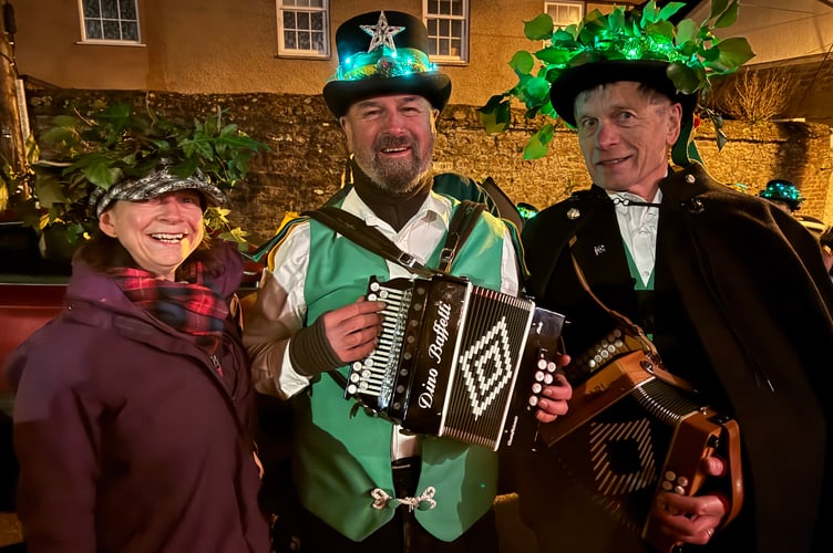 Sue Charnock from Sandford was Wassail Queen, pictured with two members of Exeter Morris.  AQ 2202
