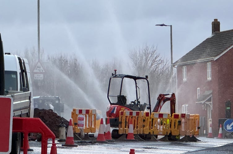 Water spraying from the burst water main in Exhibition Road. AQ 2359