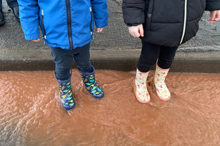 Children enjoyed playing in the water running along Exhibition Road. AQ 2353