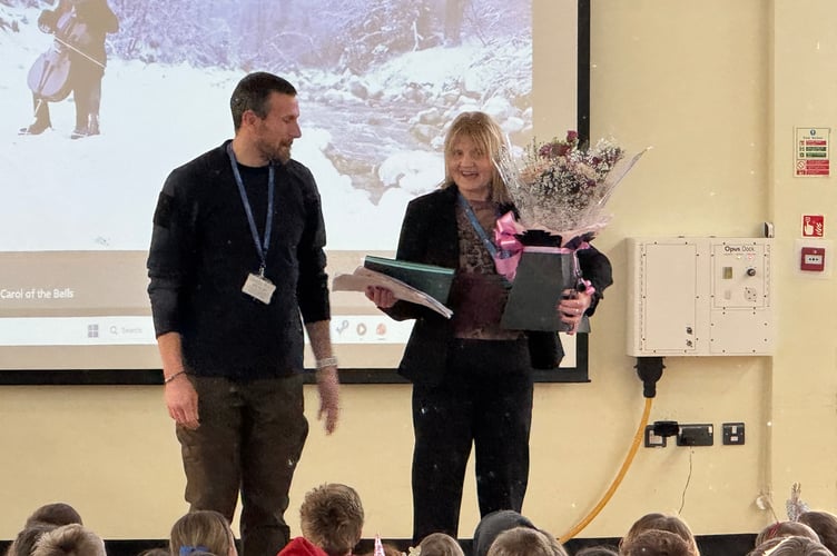Teacher Miss Brown received gifts, flowers and cards for her long service at Landscore Primary, with Head Teacher Tim Williams, left.  AQ 0835
