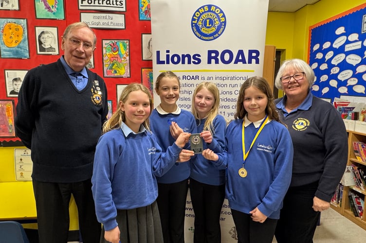 Four Landscore pupils have won the Lions SW ROAR award for their idea of a watch to alert people with sight and hearing impairments of impending danger. They received the award from Crediton Lions President Ann Whitehouse and Lion Eric Parkes.  AQ 2811
