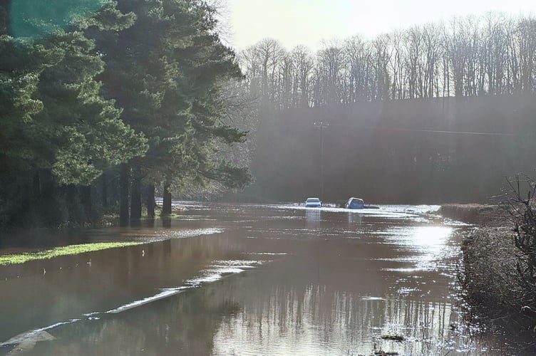 Abandoned cars in floodwater on the A377 at Ladds Guns