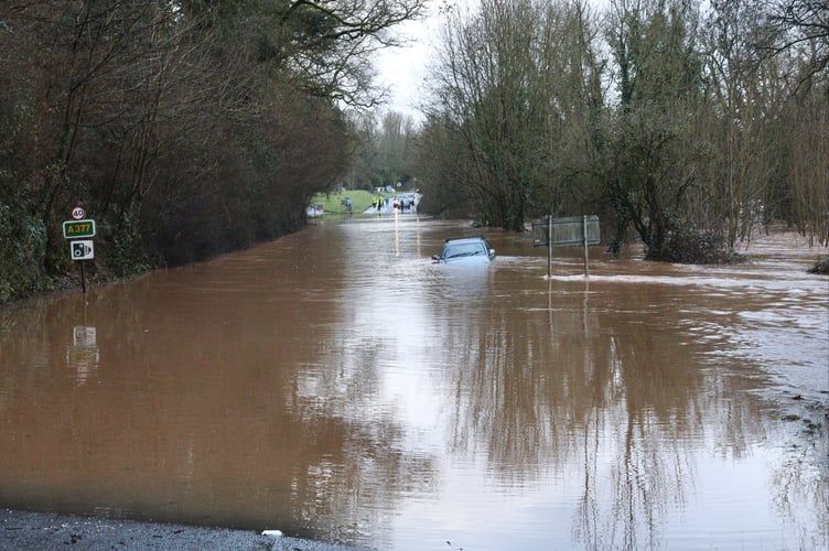 Flooding at Half Moon. An abandoned car can be seen in the floodwater