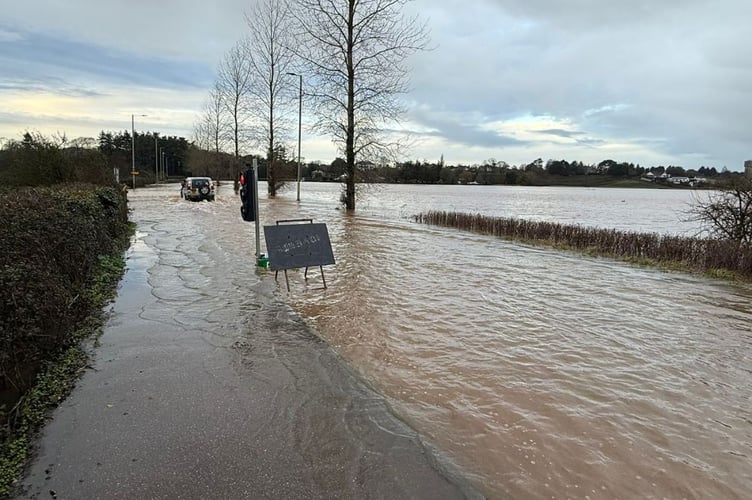A flooded Devon road during Storm Chandra.
