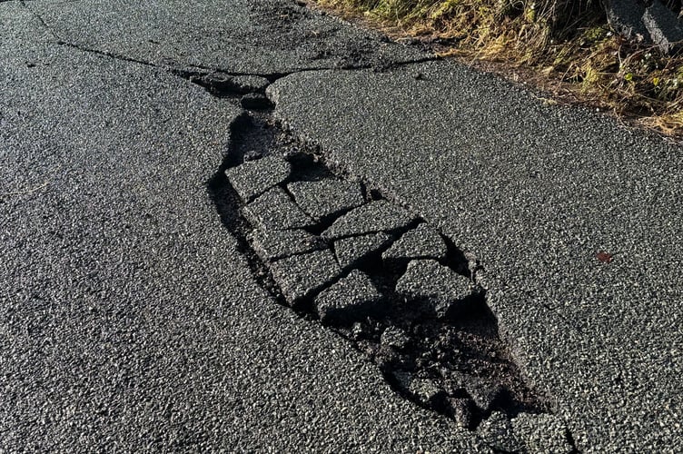 One of the smaller sections of roadway which has been washed away by the floodwater.  AQ 3189
