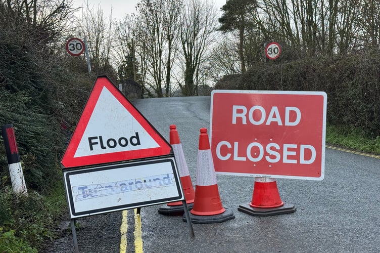 Flood and road closure signs in Station Road, Newton St Cyres.  AQ 3219
