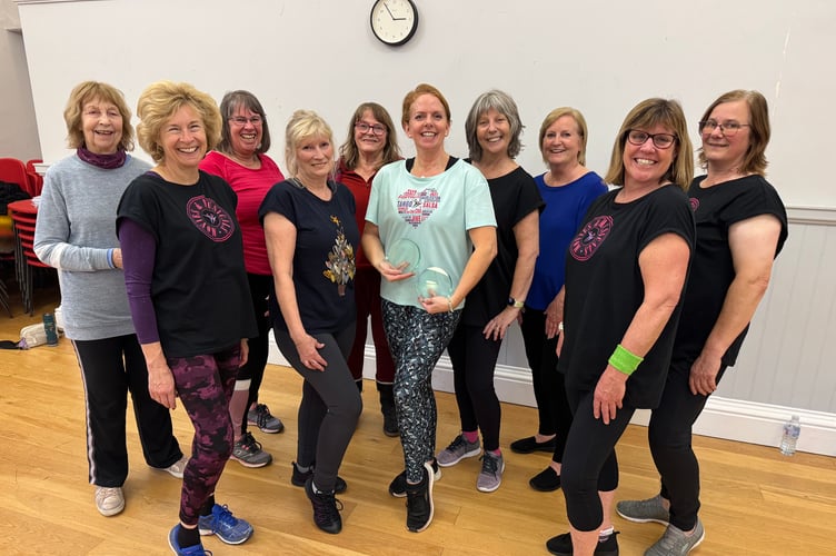 Elaine Coldman holding her awards with some of her class members at the Old Town Hall, Crediton. AQ 9965
