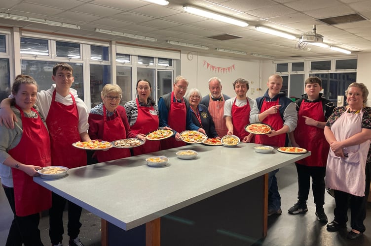 The group with their pizzas ready for the oven