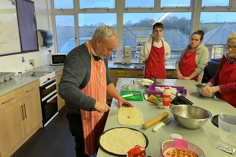 QE technology teacher Wilf Richer showing how to make garlic bread