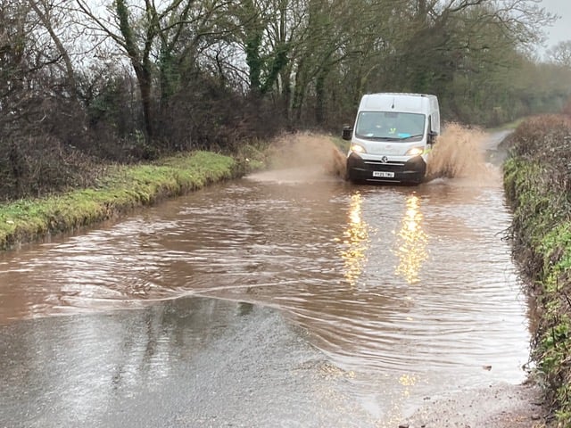 A van travelling through the floodwater on Higher Road, Crediton.
