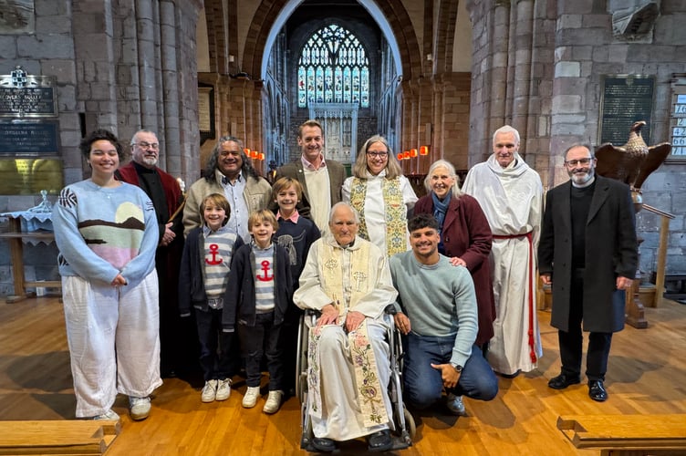 Rev Michael Hall, front, centre, in his wheelchair, with members of his family and Crediton church officials with Rev Matthew Tregenza, right.  AQ 4612
