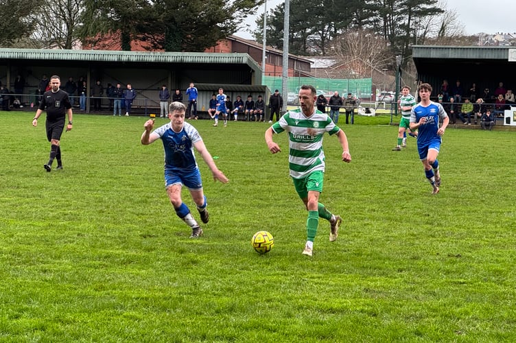 Crediton, in blue, about to gain possession during a recent home game.  AQ 4916
