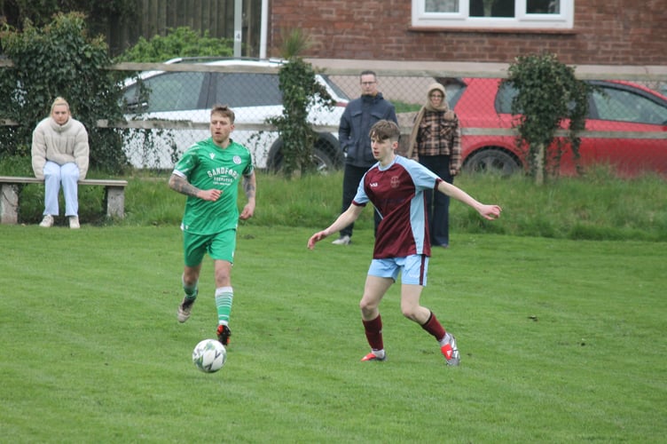 League leaders North Tawton took the honours in the game against Sandford.  AQ 1044
