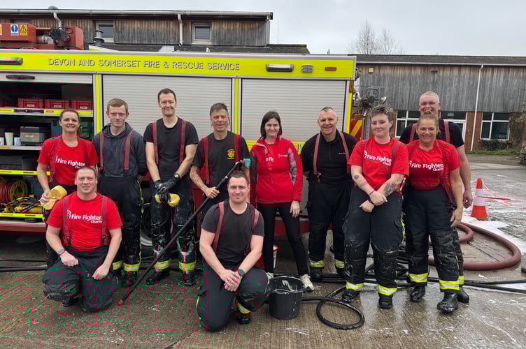 Some of the Crediton firefighters who took part in the charity car wash. AQ 5814
