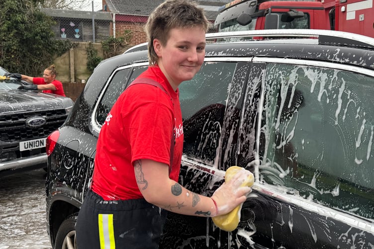 Washing a car at the charity car wash.  AQ 5831
