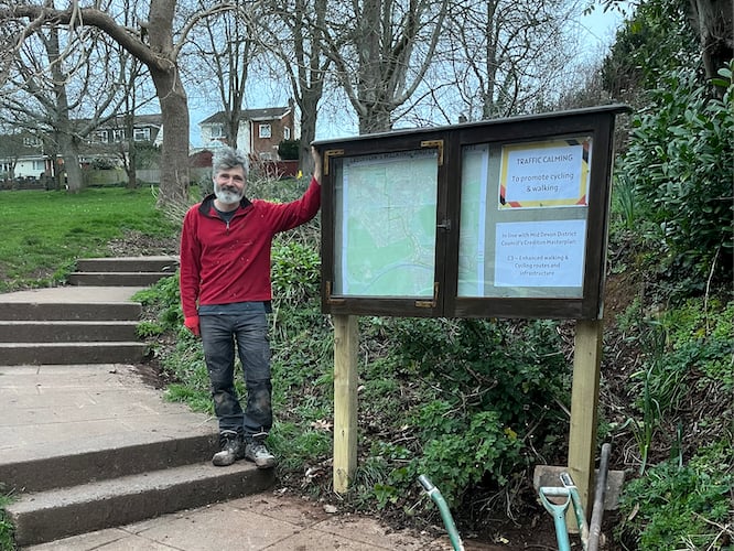 Crediton Town Councillor Giles Fawssett with the new noticeboard at People's Park.
