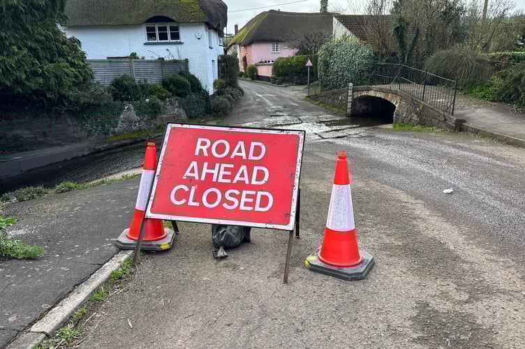 Pump Street, Newton St Cyres has been closed, the ford across Shuttern Brook in the foreground.  AQ 6366
