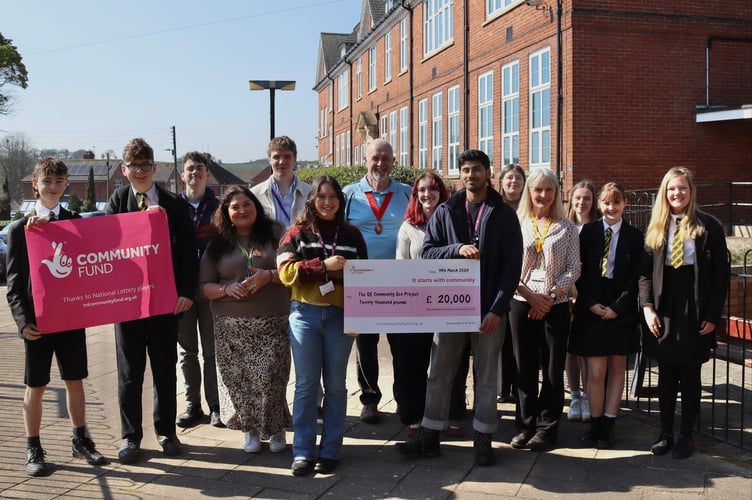 QE students celebrating with Tamlyn Fraiquin, fourth from left, and Mayor of Crediton Steve Huxtable, centre