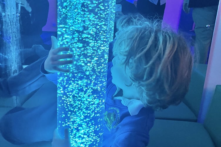 23 March 2026 Cheriton Fitzpaine Primary School sensory hub 6x pic special Pupil enjoying a tube filled with colourful bubbles (Will Goddard, Crediton Courier)