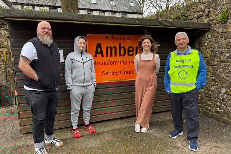 Marking more than 9 years of support for Amber, Nick Arnold, right, from Crediton Boniface Rotary, with, from left, Ashley Court’s Service Manager Christian Sculpher, resident Diamond, Amber Fundraising and Communications Manager Becky Fry.  AQ 6733
