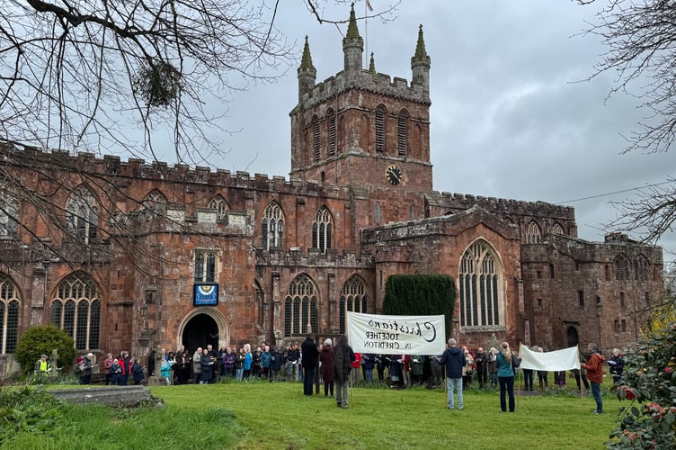 The Walk of Witness stopped for prayers, a hymn and readings at Crediton Parish Church.  AQ 7579
