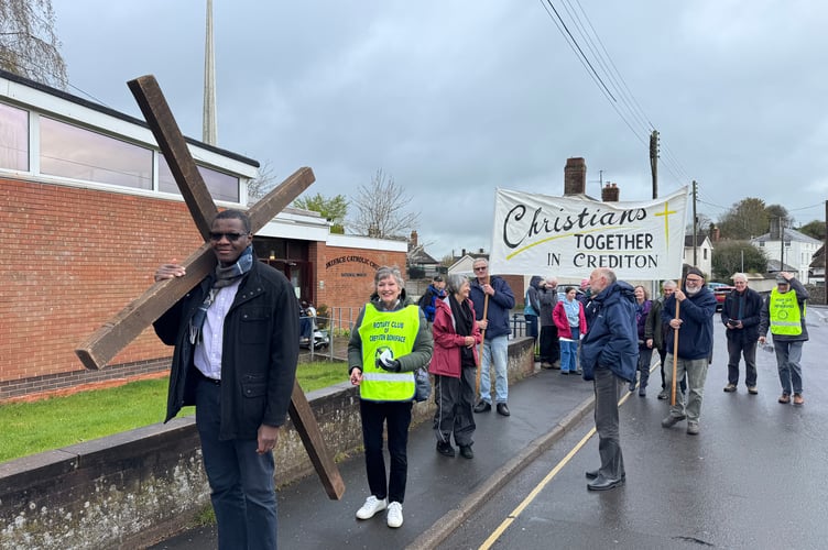 The Walk of Witness leaving the St Boniface Roman Catholic Church with a volunteer carrying the cross.  AQ 7551
