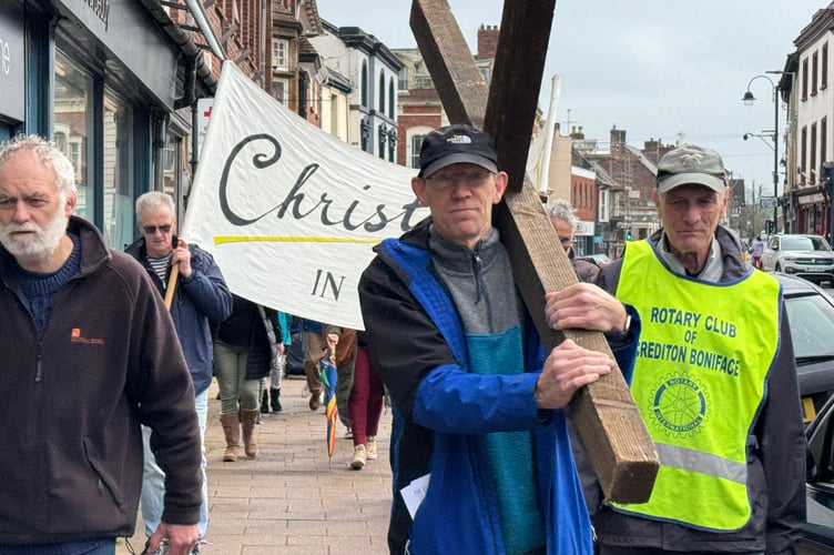 Carrying the cross in Crediton High Street during the Walk of Witness.  AQ 7655
