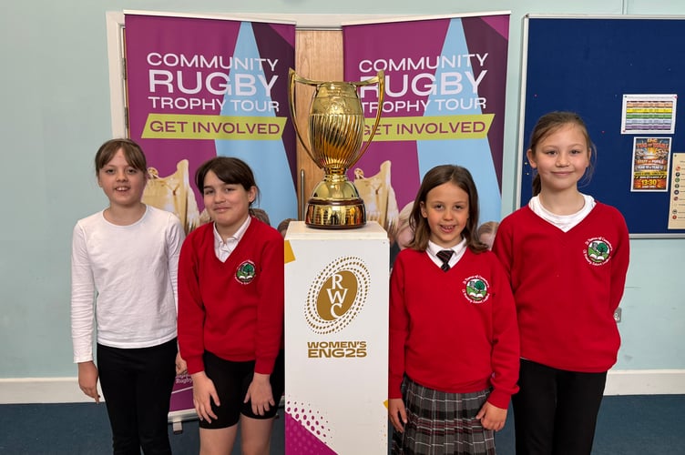 St Thomas of Canterbury CE Primary School girls with the Women’s Rugby World Cup Trophy. AQ 7407