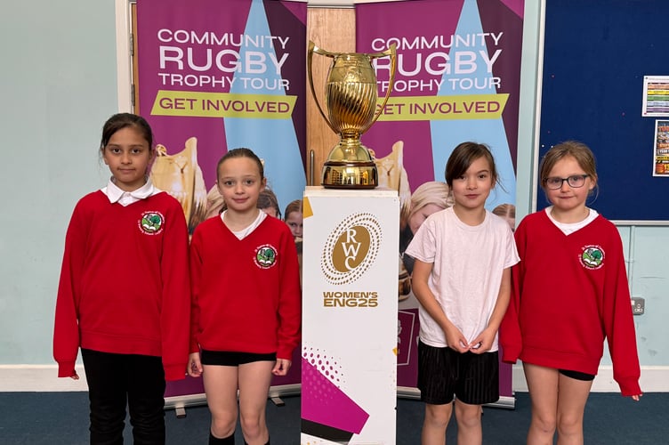 St Thomas of Canterbury CE Primary School girls with the Women’s Rugby World Cup Trophy. AQ 7467