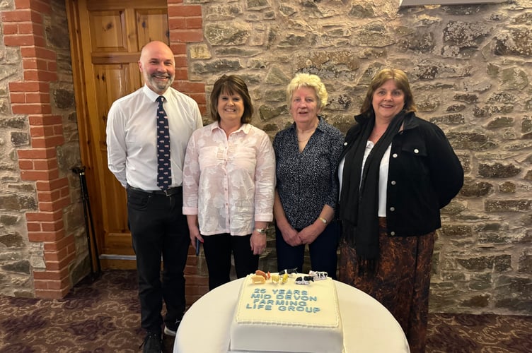 At Mid Devon Farming Life Group celebration, from left, Dan Downs with Ruth Friend, Margaret Harris who made the celebration cake and Sarah Chown.  AQ 6808
