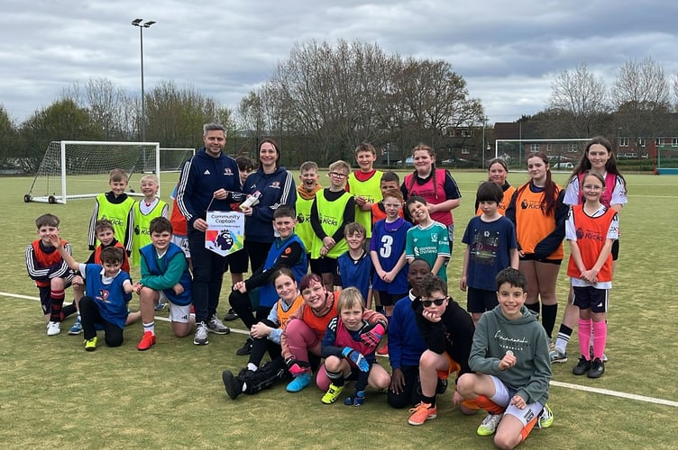 Danny Harris, Head of Services at Exeter City Community Trust (ECCT), presenting Laura Evans with the Exeter City's Premier League Community Champion award.
