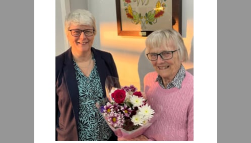 President Jane, presenting Tedburn St Mary WI member Sheila with a 90th birthday bouquet.