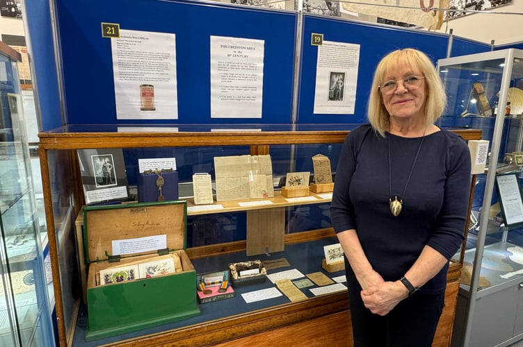 Cheryl Lewis beside a fascinating display about West Sandford man Sidney James military career and life at Crediton Museum.  AQ 8157
