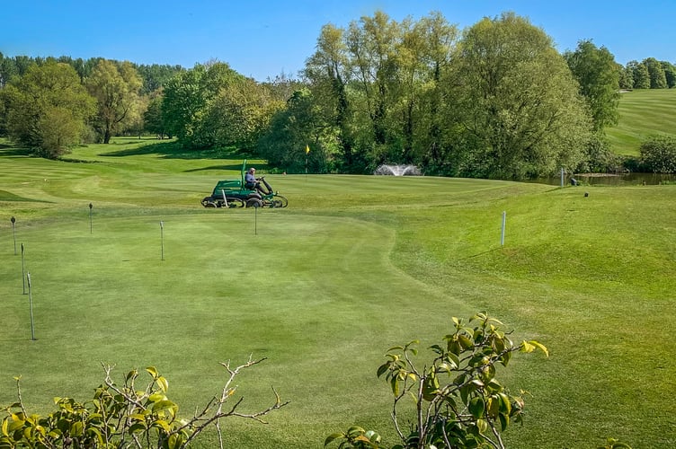 Finishing touches around the 18th green. 
