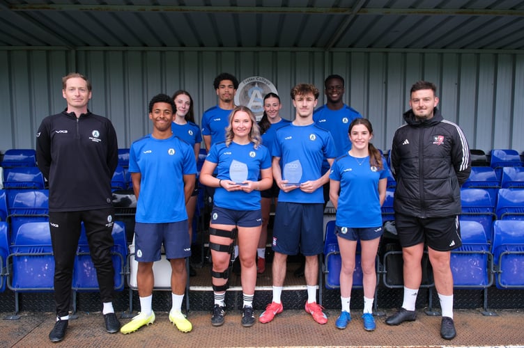 Coaches and players with trophies