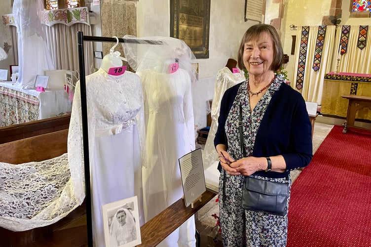 Patience Williams with the dress (far left) she was married in at St Mary's Church in 1970. Her sister Margaret, whose dress hangs alongside, was also married there