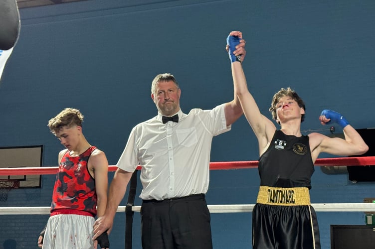 The winner is declared after one of the boxing bouts.  AQ 9489
