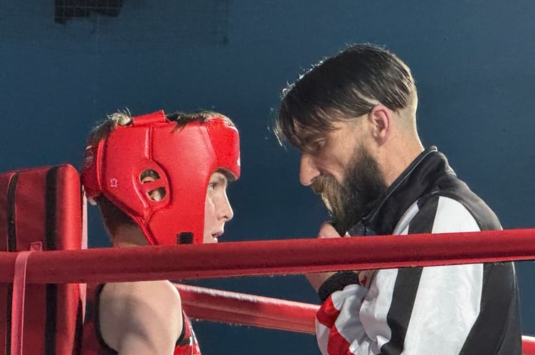 Bang Bang Boxing head coach Jamie Parker advises one of the young boxers.  AQ 9393
