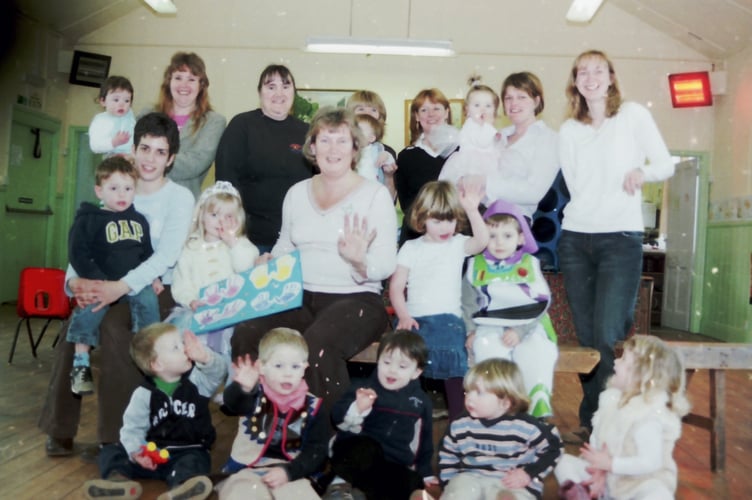 Children at Yeoford Playgroup with leader Rose Billson, centre and members of staff in February 2006. DSC00632