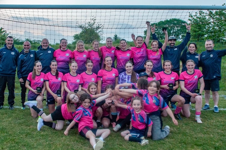 Crediton United ladies with the DWFL North and East divisions regional final cup, their managers and coaches and Under 9’s girls team mascots.