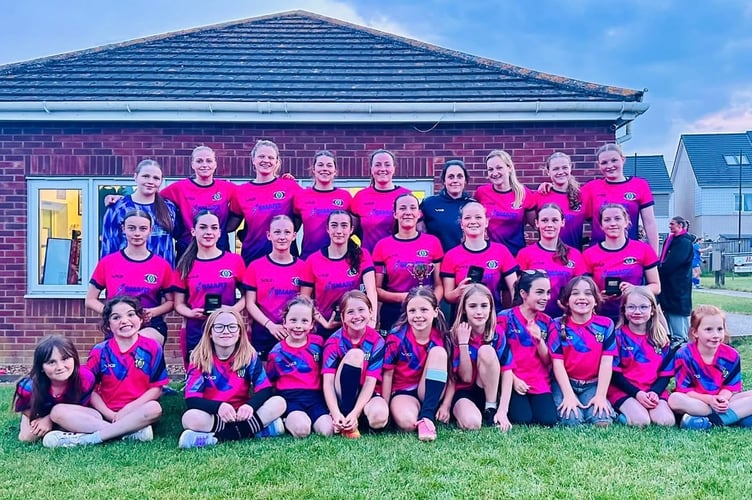 Crediton United ladies with the DWFL North and East divisions regional final cup and Under 9’s girls team mascots.