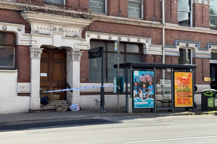 The taped off steps and bus stop near the former Lloyds Bank premises in Crediton High Street.  AQ 0538
