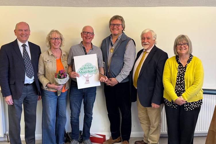 Cllr Les Partridge, third left, receives a card and award from Morchard Bishop Parish Council chairman Simon Baker, with left, clerk David Parker and Mrs Caroline Partridge and right, County Councillor Steve Keable and council deputy chairman Dawn Parkhouse. AQ 0571